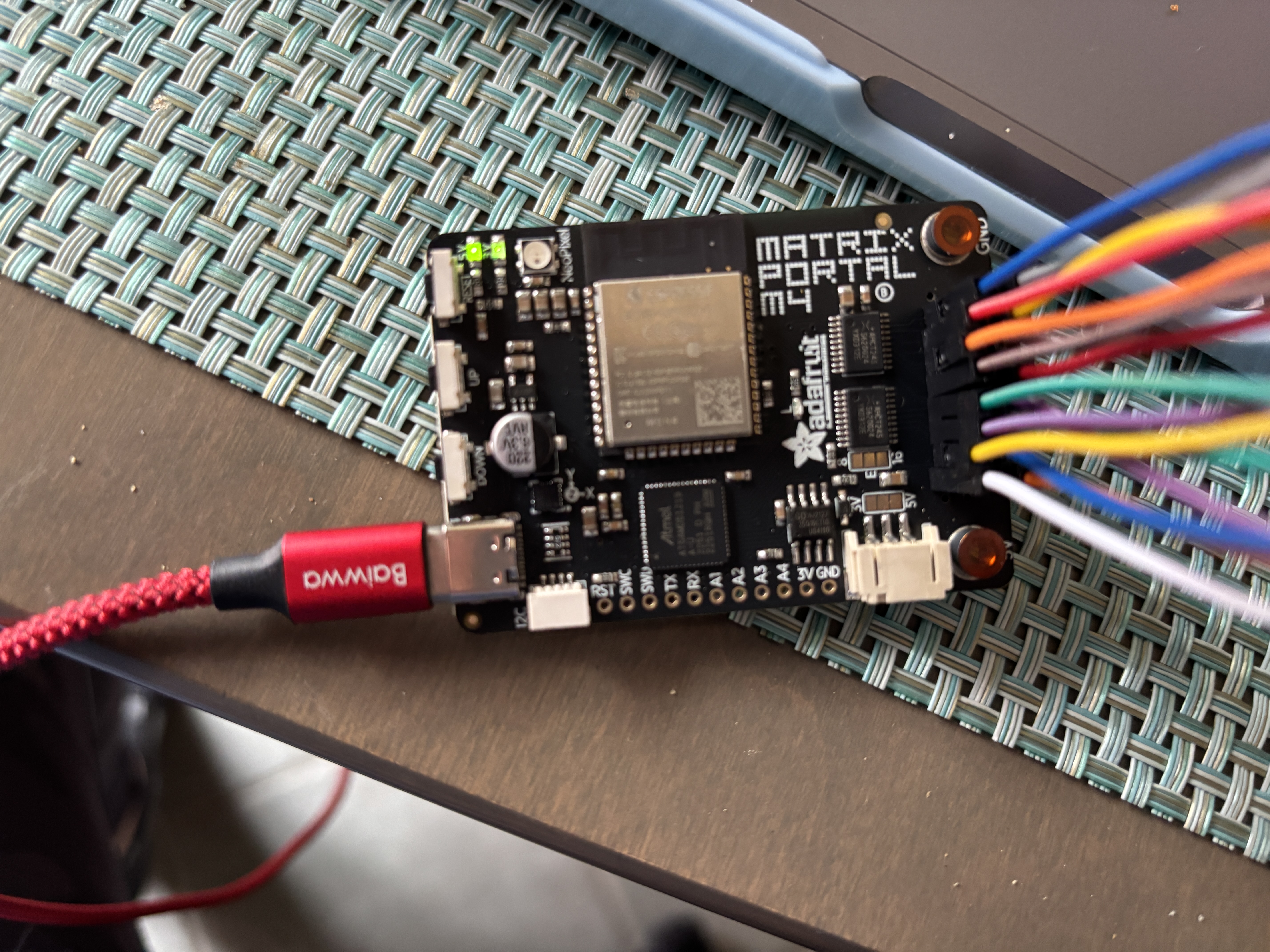 Figured out I needed an Pitch 16 Pin Straight Box Header since i had two male ends to my connecting and the matrix portal for the mean time I am using wires it is currently in transit. The ADAFRUIT MATRIX PORTA is working as we can see as I turned it on and the lights are working